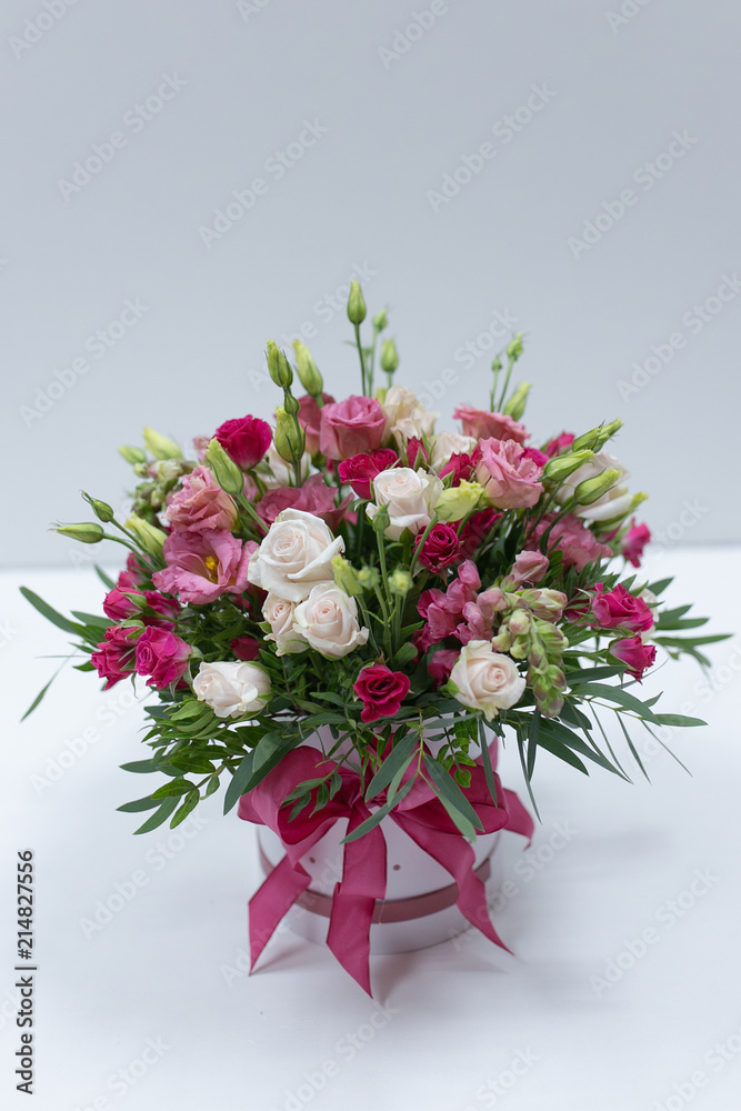 Bouquet festive with pink and red roses in a pink gift box