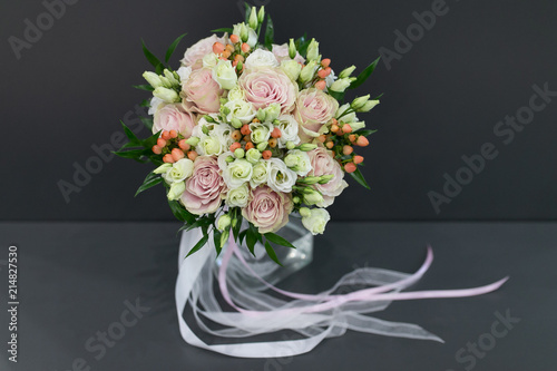 Bouquet for the bride of white and pink roses with delicate ribbons (in a white vase)