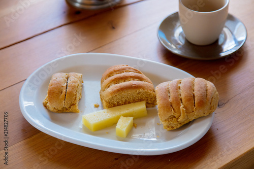 Traditional Crete breakfast, bread, cheese and coffee on wooden table on a kitchen. Crete, Greece