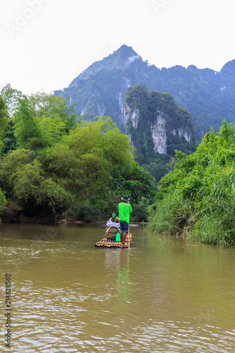 River rafting on bamboo rafts, Thailand. River between the mountains in the jungle.