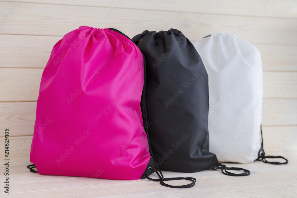 Three drawstring pack template, bag for sport shoes isolated on white - obrazy, fototapety, plakaty 