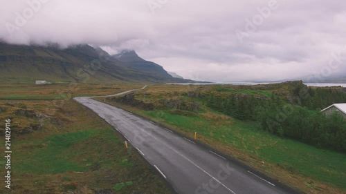 Curve line road cloudy day, dramatic Icelandic landscape, handle shot photo