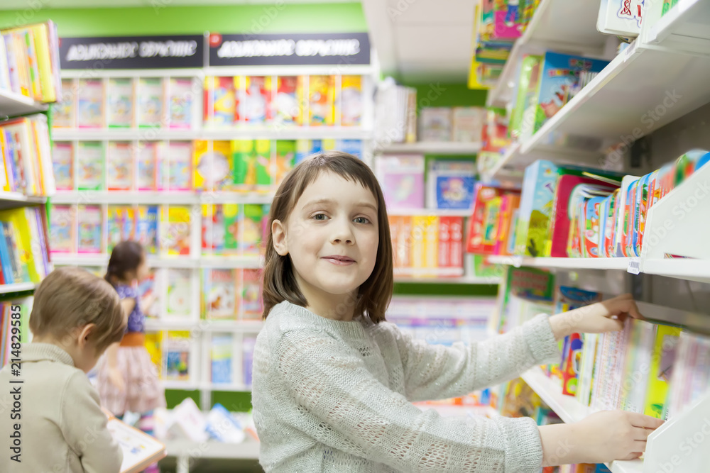 first grader  choosing   books in   bookstore for school