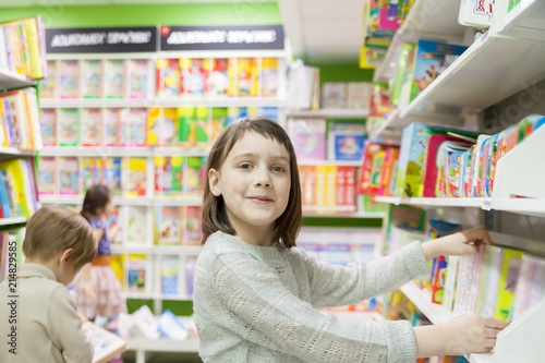 first grader choosing books in bookstore for school