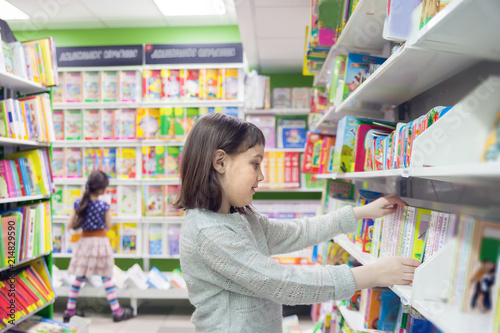  first grader choosing books in bookstore for school