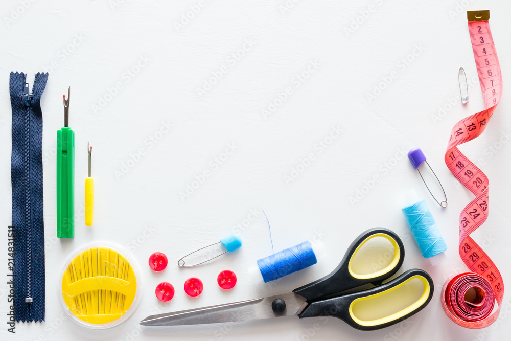 Thread and sewing accessories on white background with place for text Thread and sewing accessories on white background with place for text
