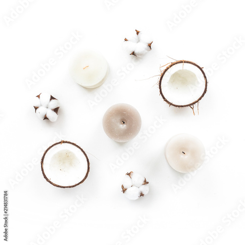 Spa composition. Cotton flowers, coconut, candles on white background, flat lay, top view