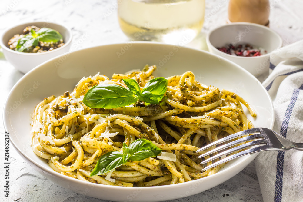 Spaghetti with homemade pesto sauce on a white background. selective focus Spaghetti with homemade pesto sauce on a white background. selective focus
