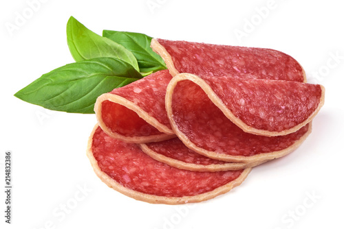 Salami with basil leaf. Smoked sausage thinly sliced, isolated on white background.
