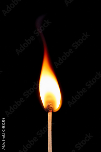 Match on fire on a black background