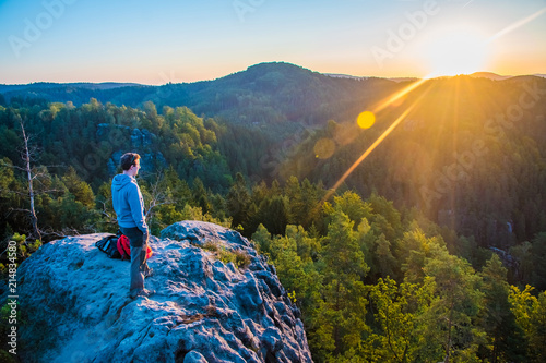 A tourist guy and beautiful morning sunrise of the Mariina Viewpoint, Bohemian Switzerland, National Park Bohemian Switzerland, Czech republic photo
