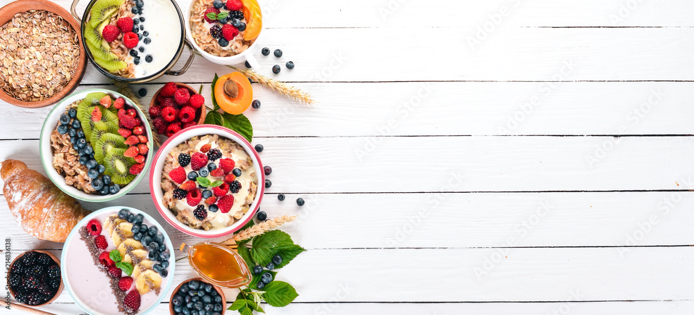 custom made wallpaper toronto digitalLarge Assortment of porridge with fruit and berries. Breakfast. On a white wooden background. Top view. Free space for text.