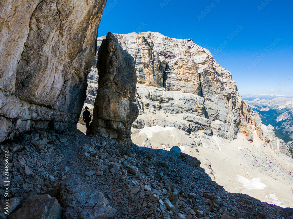 Via ferrata Tofana di Mezzo climbers on the ridge in the Dolomites, Group of climbers on the mountain top, Dolomite Alps, Italy. Silhouette of people climbing the mountain. Tiny Man Big Landscape Via ferrata Tofana di Mezzo climbers on the ridge in the Dolomites, Group of climbers on the mountain top, Dolomite Alps, Italy. Silhouette of people climbing the mountain. Tiny Man Big Landscape