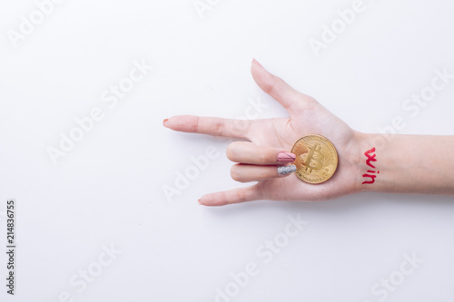 A hand with Win inscription holds a bitcoin in hands photo