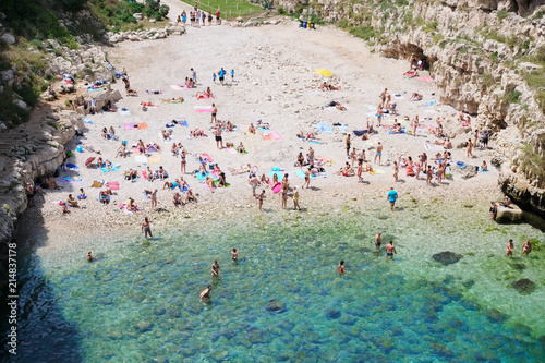 Fototapeta Naklejka Na Ścianę i Meble -  Vacationers on a stony beach on the Adriatic coast. Italy