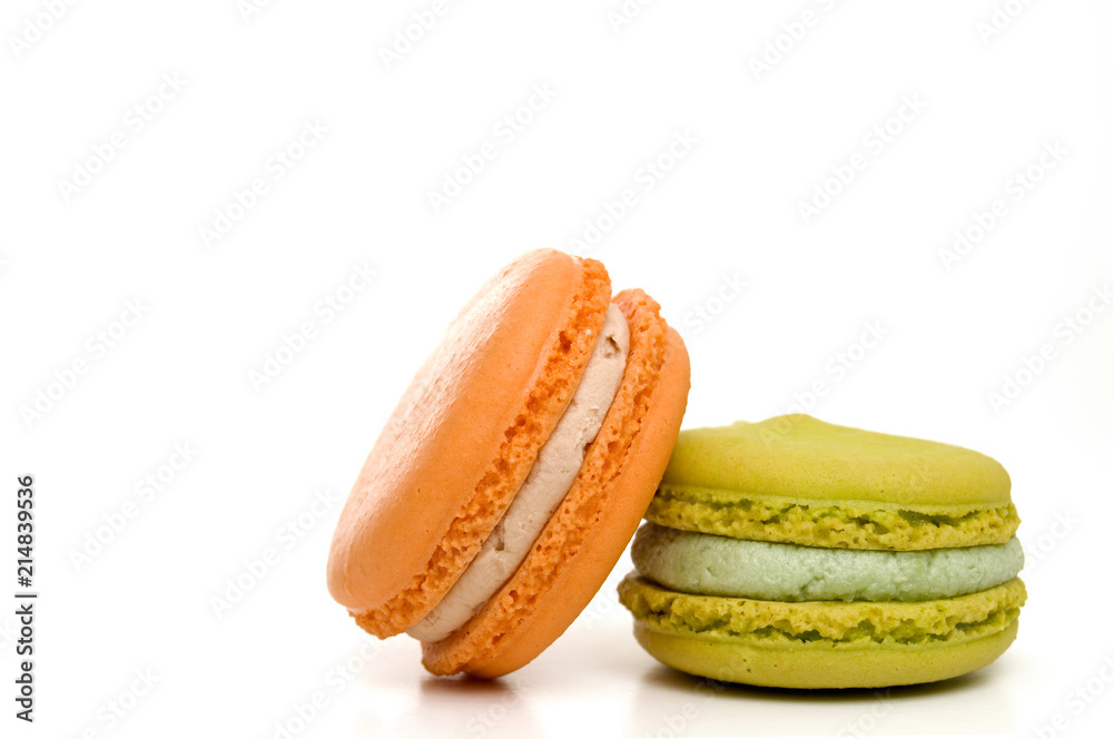 Delicious Isolated Orange and Green Stacked Macarons Delicious Isolated Orange and Green Stacked Macarons