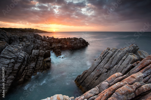 Beautiful sunset over the sandstone cliffs along the coastline of De Kelders in Gansbaai in the Overberg of south africa