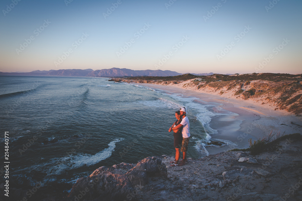 Fototapeta premium A couple looking over the ocean at th efamous De Kelders in Gansbaai in the Overberg region of south africa