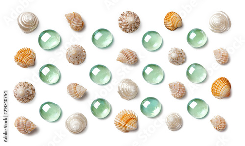 Pattern made of shells and green glass beads isolated on white background