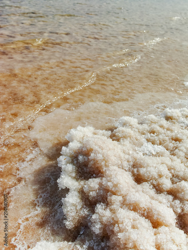 Dead Sea salt, lowest salty lake in world below sea level in Israel and Jordan, full of minerals near Ein Bokek, perfect place for medical treatments, climatotherapy, thalassotherapy and heliotherapy. photo