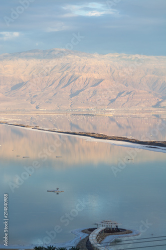 Sunset over lowest salty lake in world below sea level Dead sea  full of minerals near luxury vacation resort Ein Bokek  perfect place for medical treatments