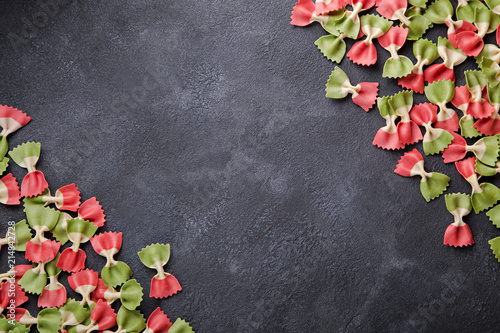 Italian flag farfalle pasta on dark background with copy space horizontal