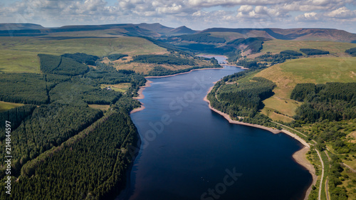 Fototapeta Naklejka Na Ścianę i Meble -  Aerial drone view of low water levels in Pontsticill Reservoir, Brecon Beacons during a summer heatwave