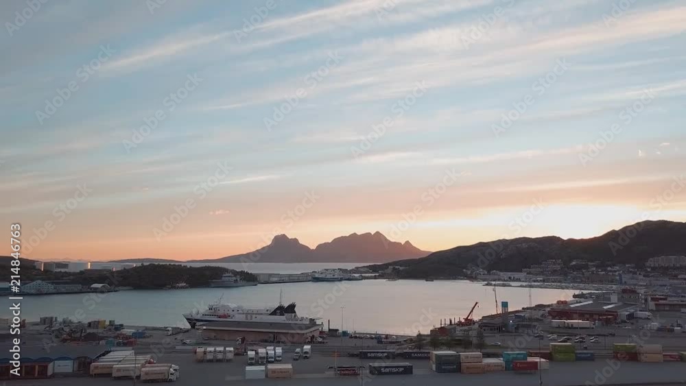 Flying by the docks in Bodø with the sun setting in the background Flying by the docks in Bodø with the sun setting in the background