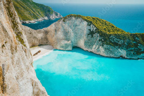 Famous shipwreck on Navagio beach with turquoise blue sea water surrounded by huge white cliffs. Famous landmark location on Zakynthos island, Greece