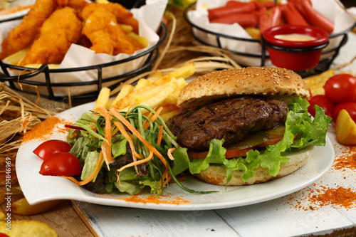 Hamburger with garnish and french fries