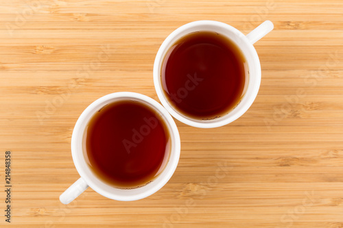 Good Morning, Two White Cups of tea isolated on a wooden background shot from above, breakfast