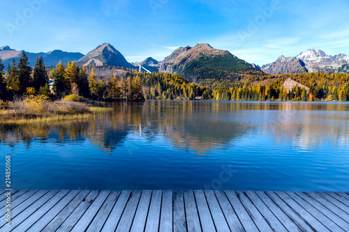 Mountain lake in the autumn season. Beautiful lake in Slovakia - Strbske Pleso. Saturated autumn colors.