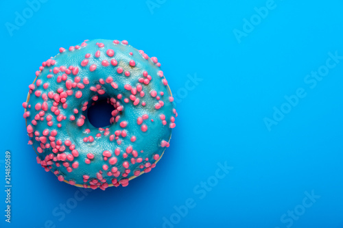 Colorful tasty glazed donut on a colored background