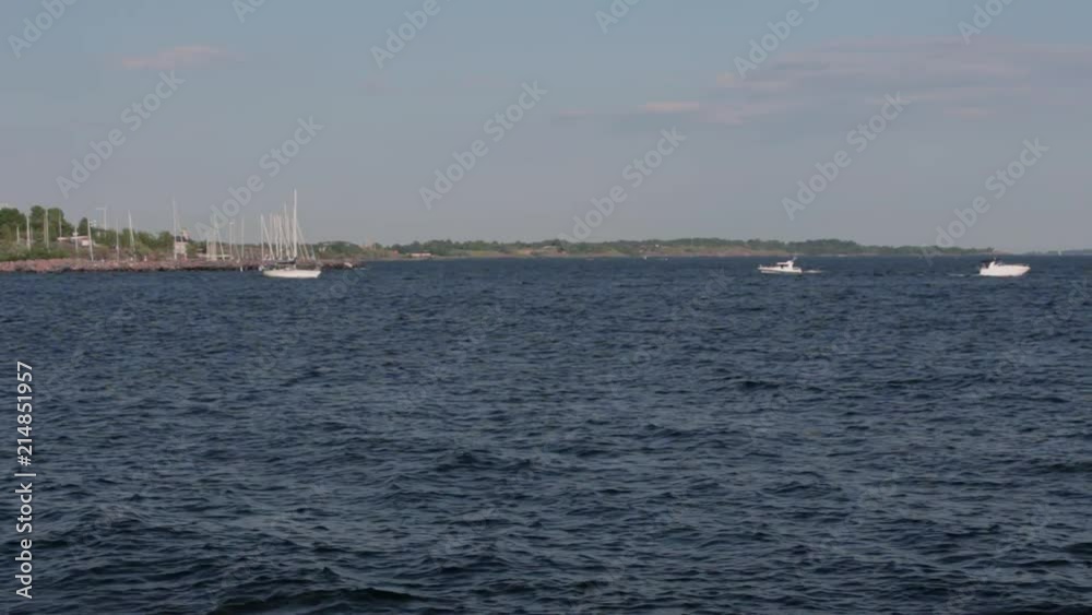 Warm beautiful day at the shore of Helsinki, Finland. Summer began and boats and ships have taken over the sea. Warm beautiful day at the shore of Helsinki, Finland. Summer began and boats and ships have taken over the sea.
