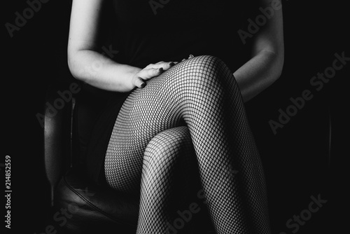 sexy women's legs in black fishnet stockings texture. woman knee in fishnet stockings
