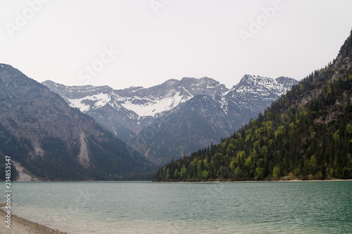 Majestic emerald mountain lake in Switzerland on the background of the Alps