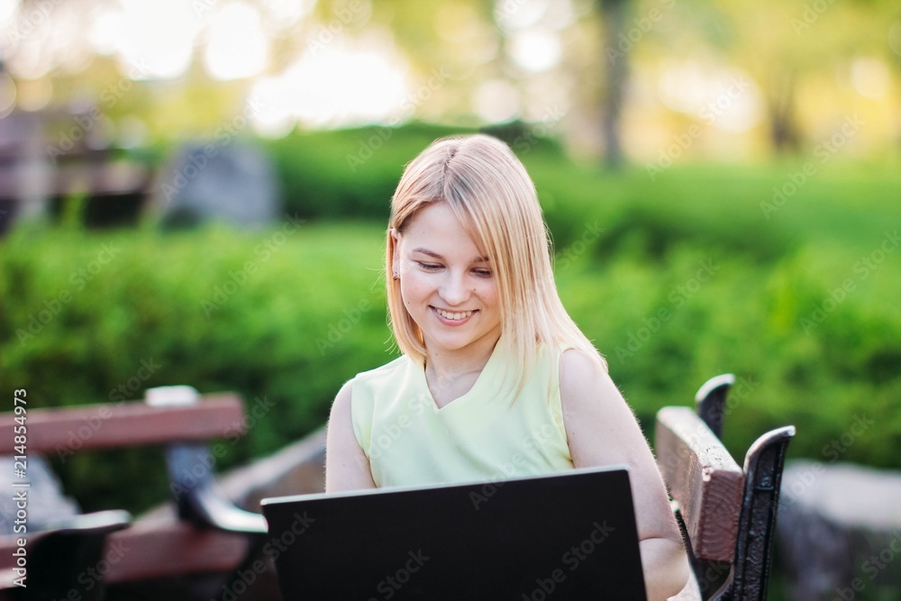 girl in park with laptop. internet connection in nature 4g, freelancing work. girl in park with laptop. internet connection in nature 4g, freelancing work.