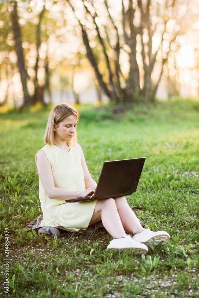 girl in park with laptop. internet connection in nature 4g, freelancing work. girl in park with laptop. internet connection in nature 4g, freelancing work.