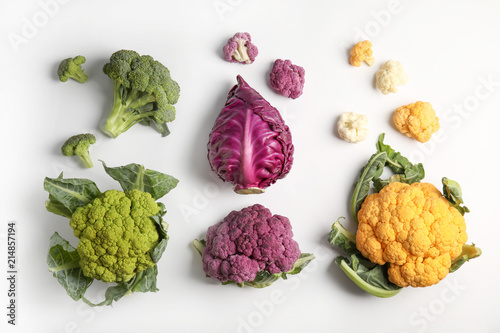 Different fresh cabbages on white background, top view. Healthy food