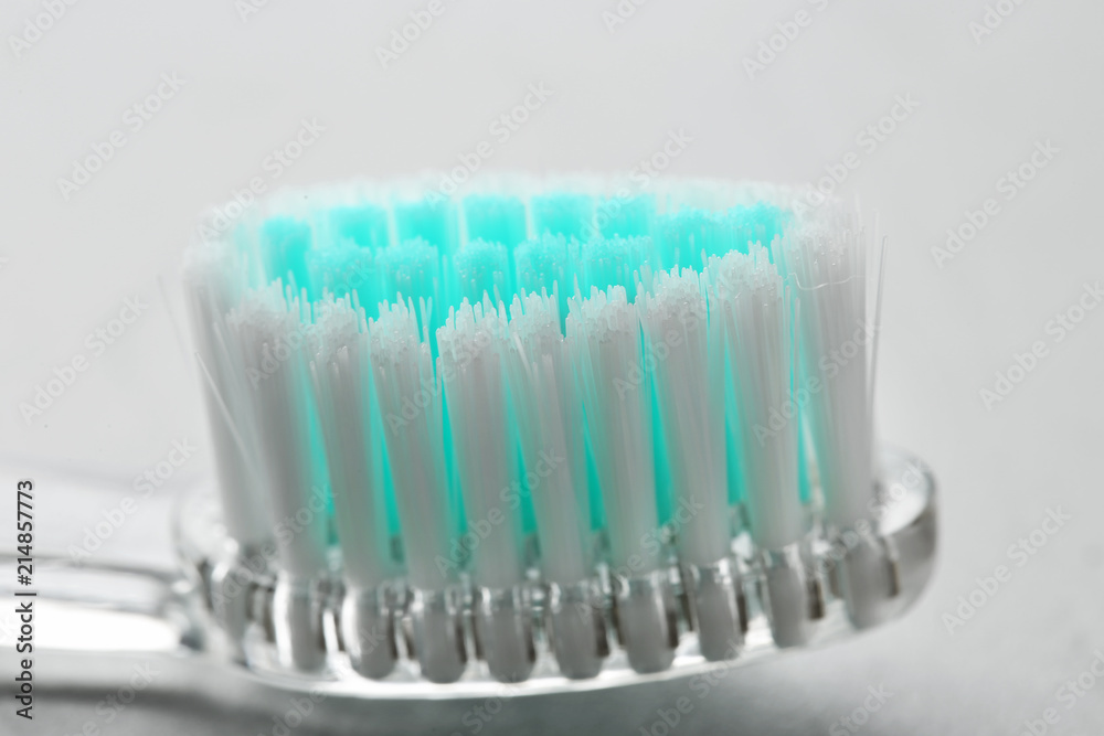 Manual toothbrush on gray background, close up