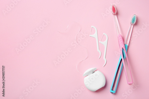 Flat lay composition with manual toothbrushes and oral hygiene products on color background