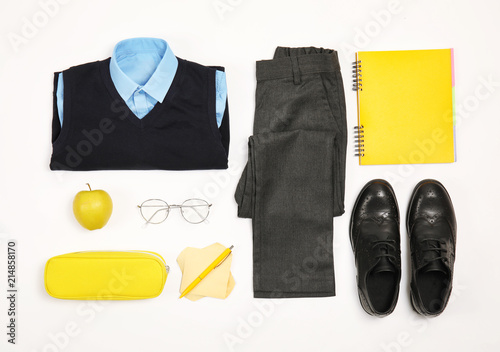 Composition with school uniform for boy on white background, top view