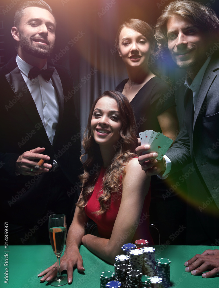 Upper class friends gambling in a casino. Upper class friends gambling in a casino.