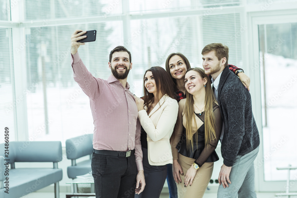 professional business team making selfie while standing near window in office