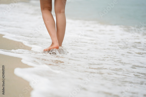 Legs of walking on beach