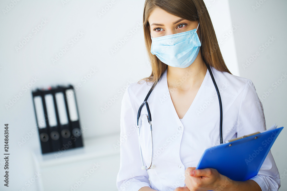 Clinic. Portrait of young doctor standing in medical office Clinic. Portrait of young doctor standing in medical office
