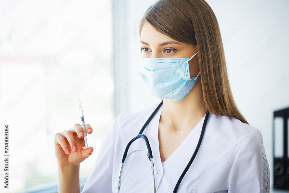 Clinic. Portrait of young doctor standing in medical office Clinic. Portrait of young doctor standing in medical office