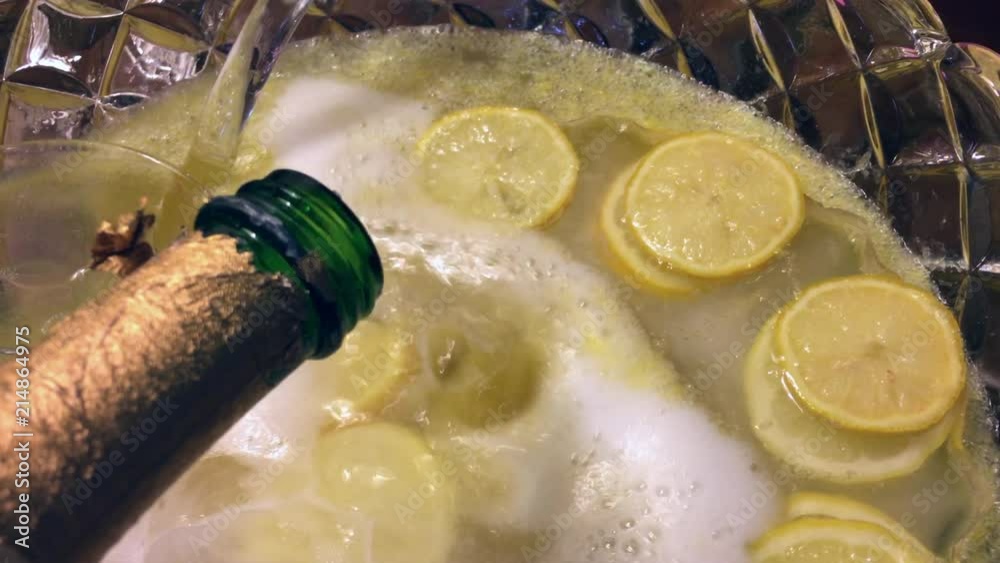 Pouring champagne into a punch bowl Pouring champagne into a punch bowl