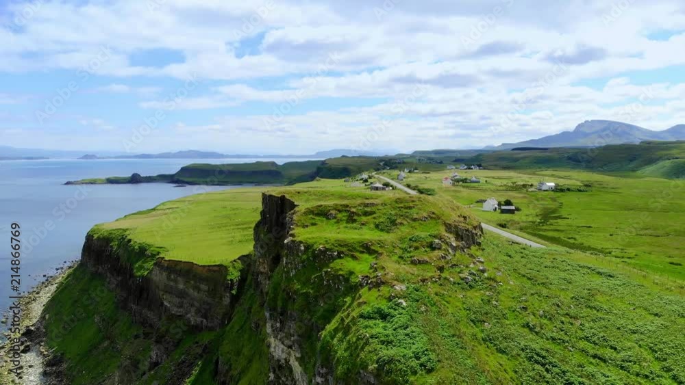 Flight over the green coastline and cliffs on the Isle of Skye in Scotland Flight over the green coastline and cliffs on the Isle of Skye in Scotland