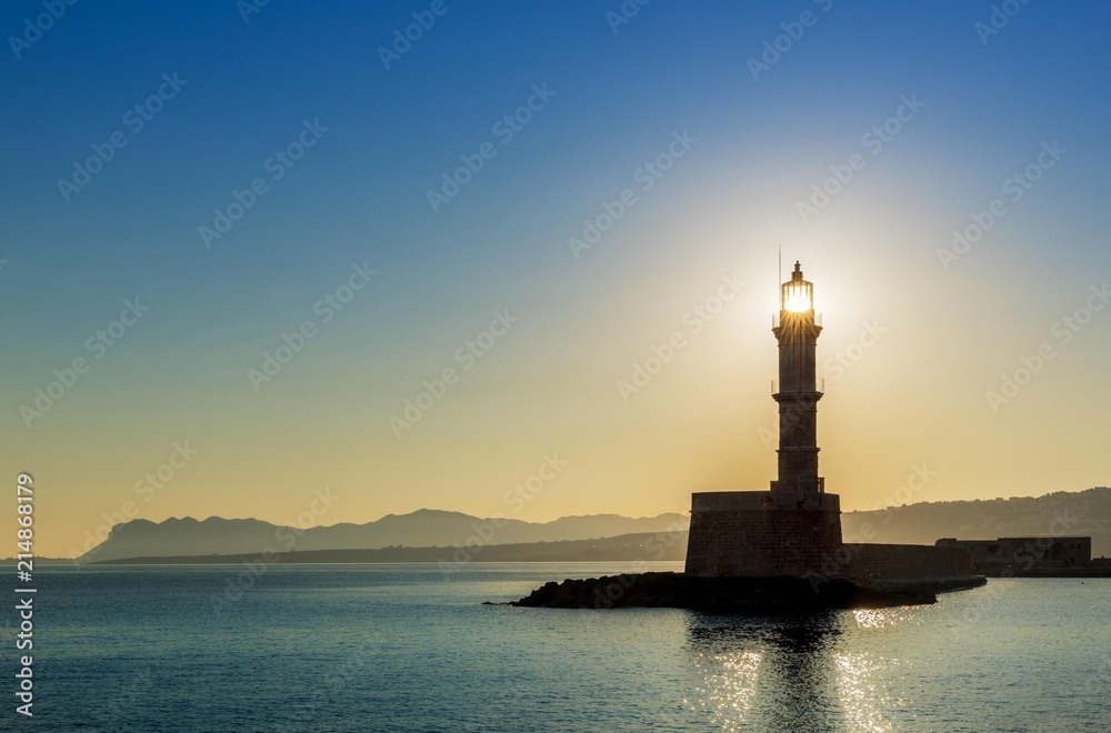 Chania lighthouse with the sun right behind, at sunrise, harbour, Chania, Crete, Greece, Europe Chania lighthouse with the sun right behind, at sunrise, harbour, Chania, Crete, Greece, Europe